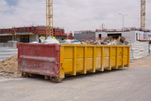 Construction waste in a Huge Overloaded 40 yard Roro. Waste metal tank container filled with construction waste, rubble near a construction site.